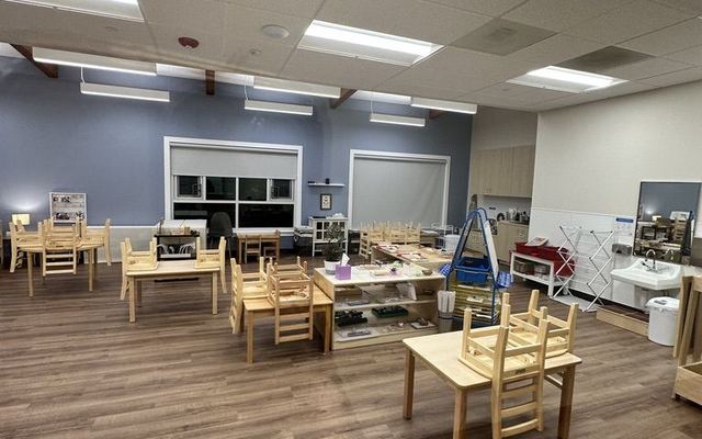 Clean classroom with tables and chairs