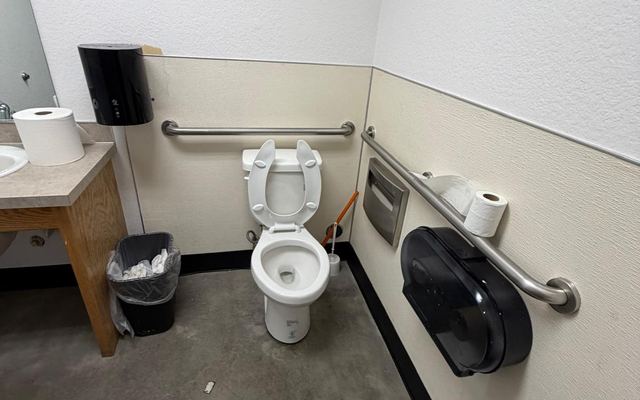 Clean, accessible commercial restroom with grab bars